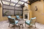 Private courtyard with lounge chairs, an outdoor fireplace and a soothing water fountain
